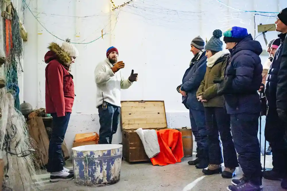 Group of people in winter clothes receiving food presentation
